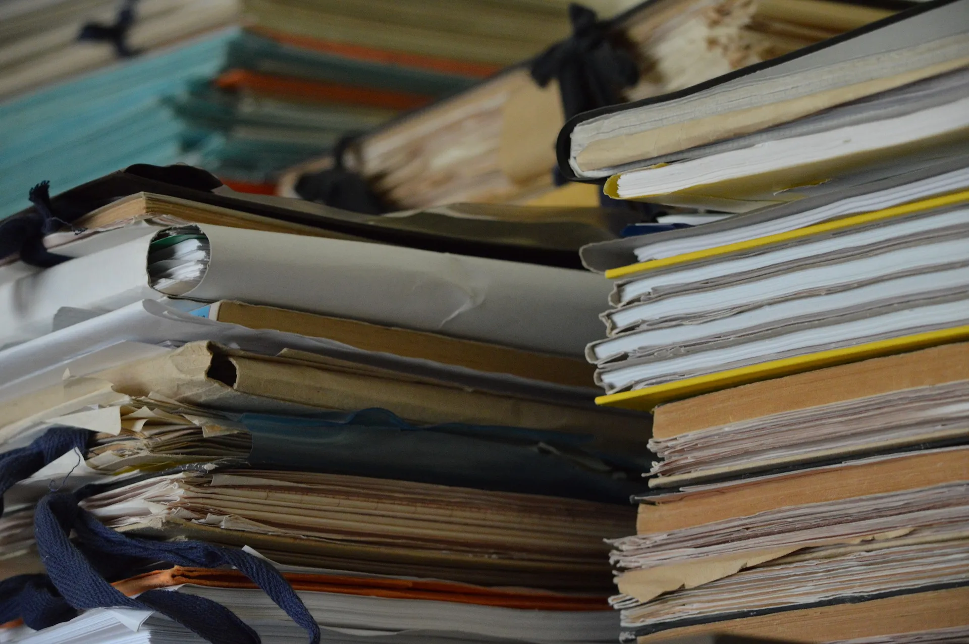 large stacks paper folders full of paper