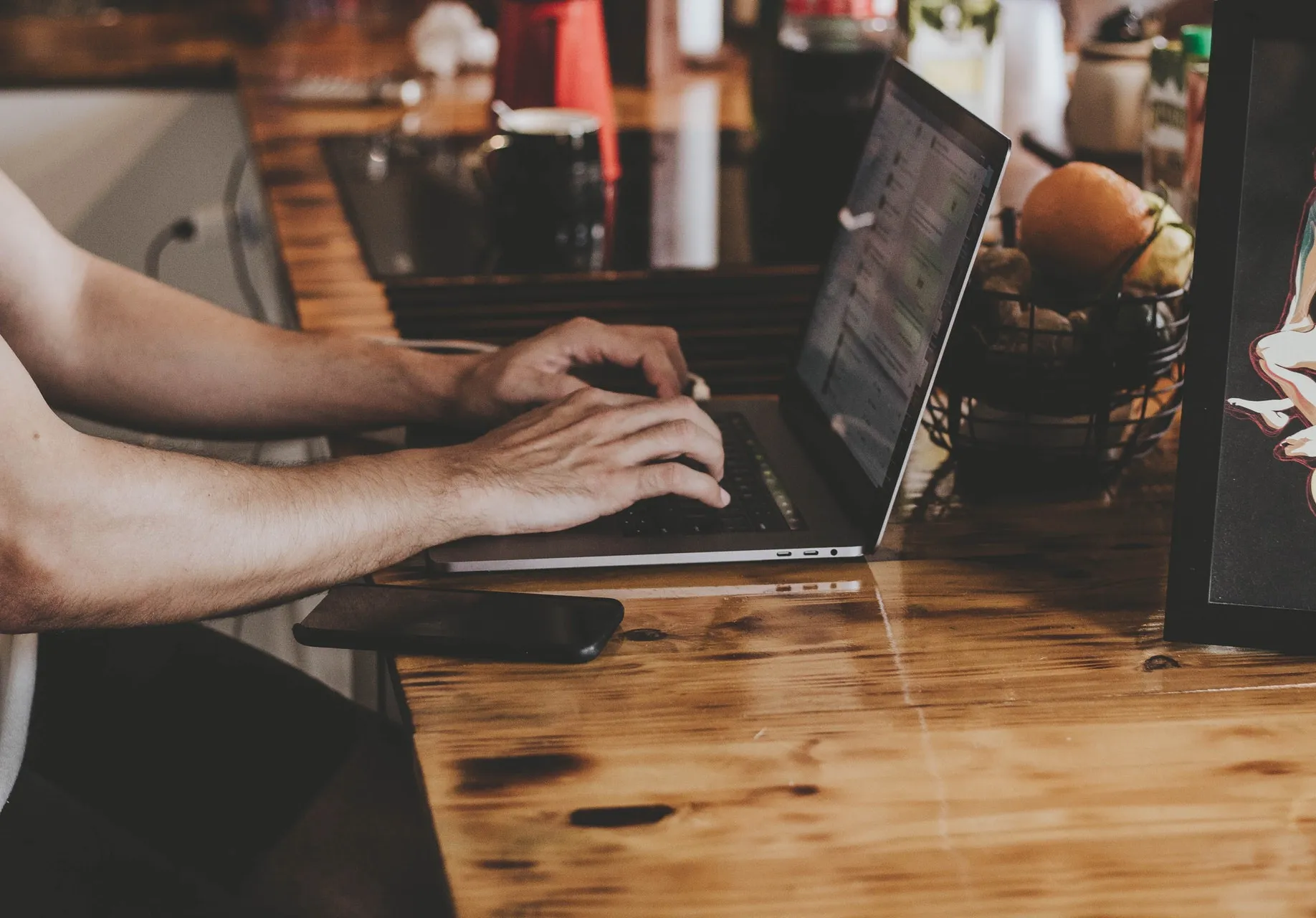 A person typing on their laptop