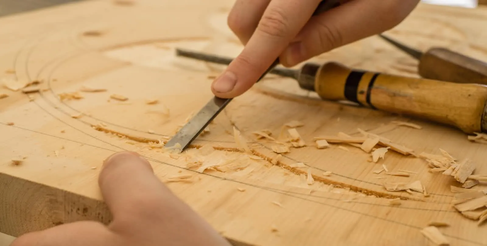a wood chisel carving an image into wood